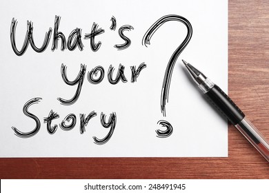 What Is Your Story?Ã?Â� Concept Written On White Paper With Black Ball Pen Aside.