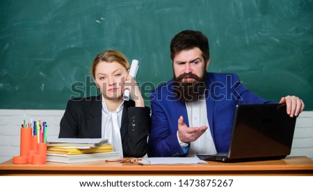 Whatever concept. School educator indifferent about and schoolmaster different opinion. School staff. School collective and colleagues relations. Teacher and supervisor working in school classroom.
