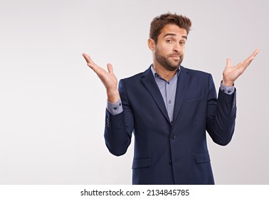 Whatever.... Studio shot of a businessman shrugging against a gray background.