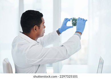 Whatevers wrong, hell make it right. a young man repairing computer hardware in a laboratory.