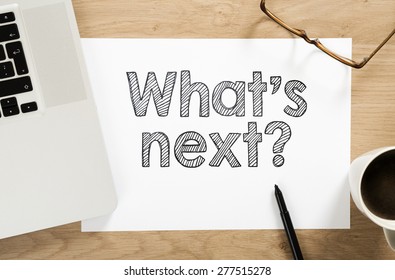 "what's next?" written paper on the office desk