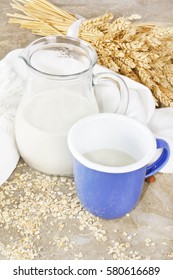 Wheat and almond milk in blue mug on vintage background
