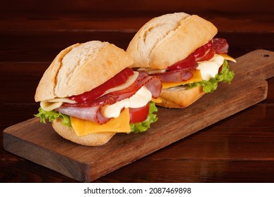 Wheat Bun Sandwiches With Ham, Smoked Sausage, Cheese, Tomato, Ketchup And Mayonnaise Sauce.