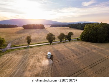 Wheat Field With Farming Combine Croping Grain. Agriculture Industry Harvest Background.