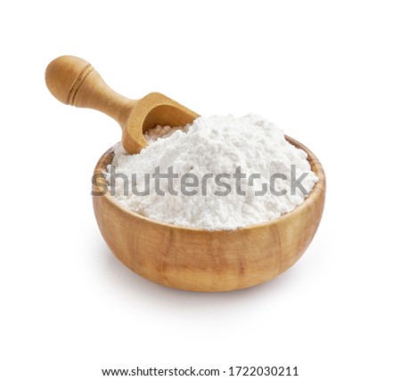 Wheat flour in bowl and spikelets isolated on white