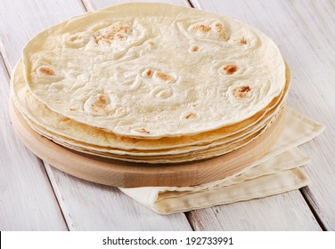 Wheat Flour Tortillas on wooden board. Selective focus
