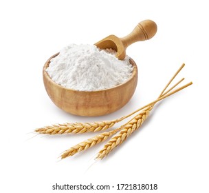 Wheat flour in wooden bowl and ears isolated on white