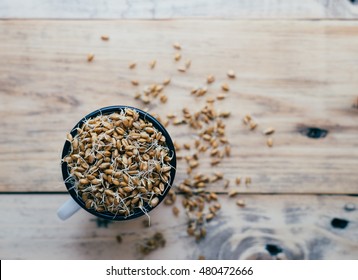 Wheat germ in a mug on a wooden table

