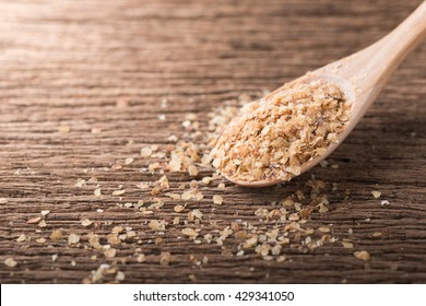 Wheat germ on wood spoon and wood background