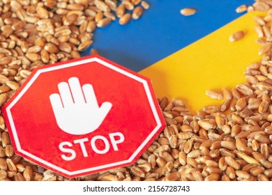 Wheat grains on the yellow and blue flag of Ukraine with a stop sign, Ukrainian grain crisis, global hunger crisis concept due to war, Food and Agriculture Organization - Powered by Shutterstock