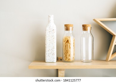 Wheat Italian pasta in glass jar on a wooden shelf in the kitchen. - Powered by Shutterstock