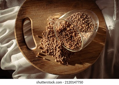 Wheat Seeds Under The Sunlight On Wood Chopper