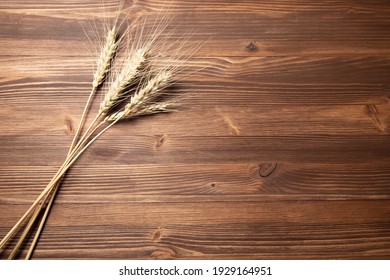 Wheat Spike On The Wooden Table Background