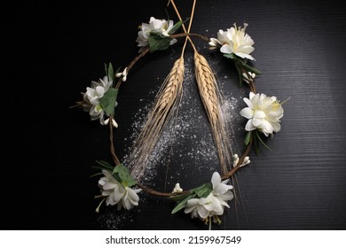 Wheat Stalks And Flower Crown On A Black Table