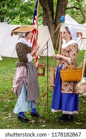 WHEATON, ILLINOIS/USA - SEPT. 9, 2018: Two Women In Period Dress Find A Moment To Chat By A Tent In A Military Camp At A Reenactment Of The American Revolutionary War (1775-1783) In Cantigny Park.