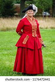 WHEATON, IL/USA - SEPT. 8, 2018: Senior Speaker With Microphone About To Demonstrate Sidesaddle Horseback Riding Technique For Women At A Reenactment Of The American Revolutionary War (1775-1783).