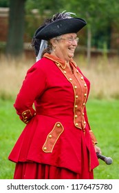 WHEATON, IL/USA - SEPT. 8, 2018: Senior Speaker With Microphone About To Demonstrate Sidesaddle Horseback Riding Technique For Women At A Reenactment Of The American Revolutionary War (1775-1783).