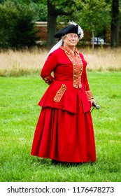 WHEATON, IL/USA - SEPT. 8, 2018: Senior Speaker With Microphone About To Demonstrate Sidesaddle Horseback Riding Technique For Women At A Reenactment Of The American Revolutionary War (1775-1783).