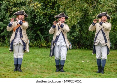 WHEATON, IL/USA - SEPT. 8, 2019: Three Fifers In Uniform, Two Young Women And A Middle-aged Man, Perform Together In A Military Camp At A Reenactment Of The American Revolutionary War (1775-1783).