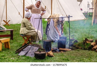 WHEATON, IL/USA - SEPT. 9, 2018: Two Mature Women In Costume Chat While A Third Checks A Pot In A Military Camp At A Reenactment Of The American Revolutionary War (1775-1783) In Cantigny Park.