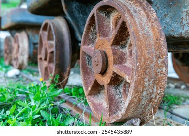 Wheel of an abandoned rusty mining wagon. Concept old style, vintage, rust metal, old school with copy space. Closeup view. High quality photo - Powered by Shutterstock