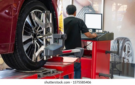 Wheel alignment ,Car on stand with sensors on wheels for wheels alignment camber check in workshop of Service station.