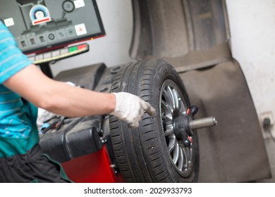 Wheel Balancing. Car wheel balance machine in auto repair