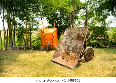 Wheel Barrow On The Grass In The Garden