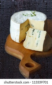 Wheel Of Blue Cheese On A Wooden Board.