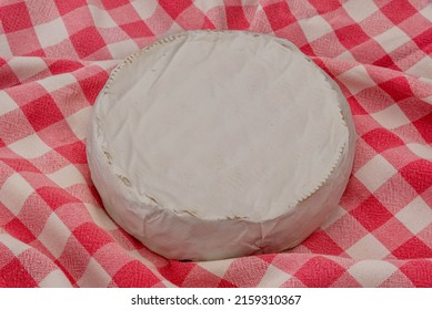 Wheel Of Brie Cream Cheese On A Red Checkered Tablecloth