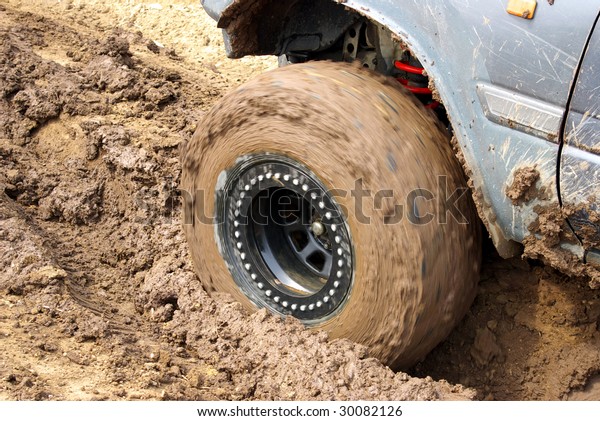 Wheel of the car in\
dirt.
