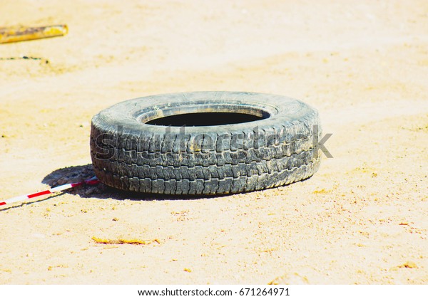 The wheel of the car\
lies on the ground
