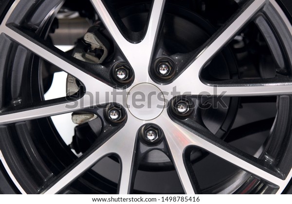 The wheel\
of the car is made of a metal alloy such as aluminum and magnesium,\
and the clean surface reflects the silver luster. It is an\
accessory for modern transportation\
wheels.