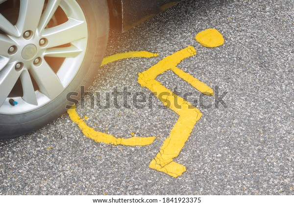Wheel car parking on handicap parking sign\
symbol at asphalt parking lot, special car parking area for\
handicapped people only, transportation convenience for disabled\
people concept\
