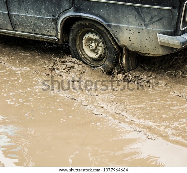 Wheel car passes
through a muddy puddle