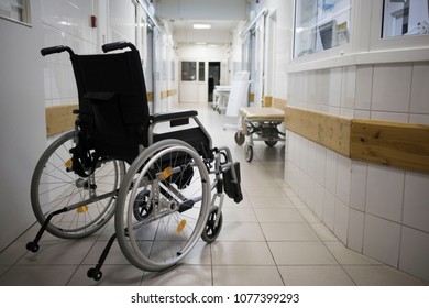 Wheel Chair At Corridor Of Hospital.