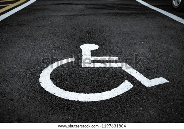 wheel chair sign on\
asphalt