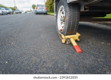 Wheel clamp anti-theft lock placed on a truck wheel