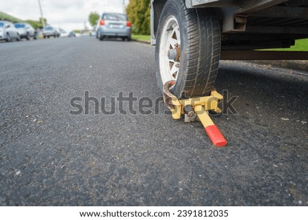 Wheel clamp anti-theft lock placed on a truck wheel