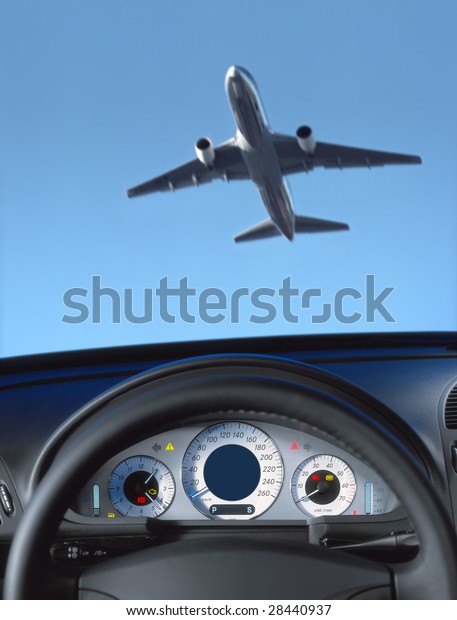 Wheel and dashboard of a car and view through\
the windshield on the\
aircraft