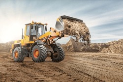 Wheel Front Loader Bulldozer Pours Sand. Distributes Sand For Road Construction. Powerful Earthmoving Equipment. Construction Site. Rental Of Construction Equipment