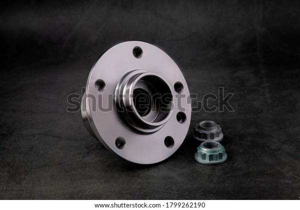 \
The wheel hub\
bearing car on a background of black marble.Concept of new spare\
parts and car repairs.\
