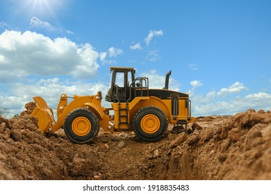 Wheel loader are digging the soil in the construction site on the blue sky  background and  sunlight