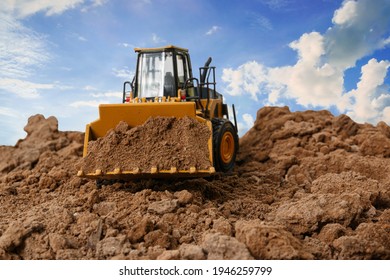 Wheel loader are digging the soil in the construction site on the  sky background . - Shutterstock ID 1946259799