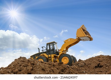 Wheel loader are digging the soil in the construction site on the sunbeam background . - Shutterstock ID 2144624597