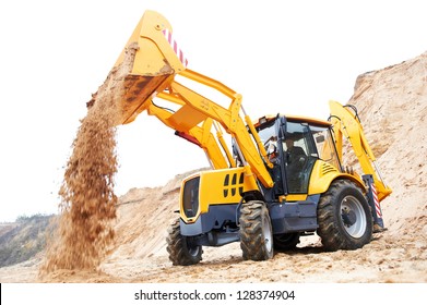 Wheel loader Excavator with backhoe unloading sand at eathmoving works in construction site