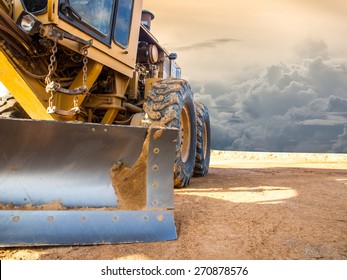 Wheel loader Excavator with backhoe unloading sand at eath works in construction site