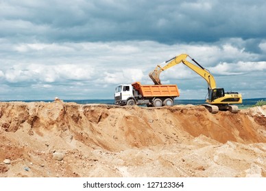 Wheel Loader Excavator Machine Loading Dumper Truck At Sand Quarry