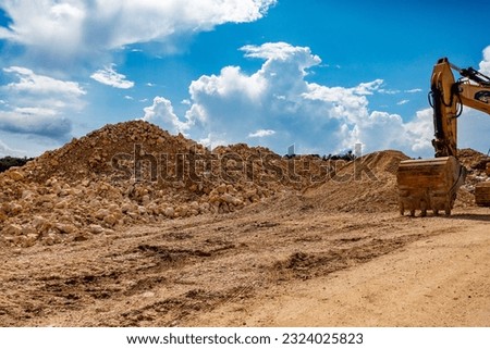 Wheel loader and excavator on a construction waste disposal site