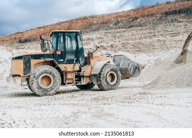 Wheel Loader With Large Bucket On Construction Site Or Quarry. Mining Heavy Machinery Details. Earthmoving, Excavations, Digging On Soils.